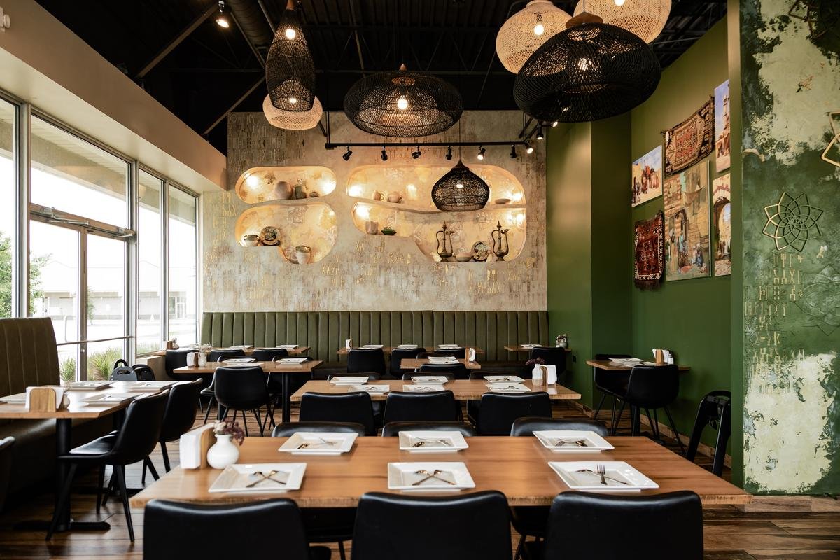 Welcoming seating layout and vintage wood door details at Sufra